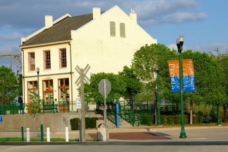 A house in Peoria, IL, behind a flag heralding its public space (photo by Patsy Wooters via Flickr Creative Commons).